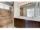 Luxurious bathroom with a tiled walk-in shower, dual sink vanity, and modern lighting fixtures for a spa-like feel at 9530 Redstar St, Las Vegas, NV 89123