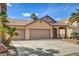 Well-maintained home with a three-car garage, terracotta tile roof, and mature palm trees in the front yard at 9530 Redstar St, Las Vegas, NV 89123