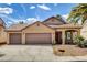 Charming single-story home featuring a three-car garage, desert landscaping, and a terracotta tile roof at 9530 Redstar St, Las Vegas, NV 89123