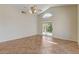 Open living room with vaulted ceiling, tile floor, and sliding glass door at 9530 Redstar St, Las Vegas, NV 89123