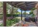 Backyard with outdoor seating area, a pergola, lush green turf and shade at 9844 Red Horse St, Las Vegas, NV 89143