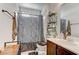 Bathroom featuring a shower with curtain, vanity, and storage shelves at 9844 Red Horse St, Las Vegas, NV 89143