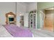 Bedroom featuring a mirrored bureau, an ensuite bathroom, and a view into the living room at 9844 Red Horse St, Las Vegas, NV 89143