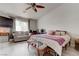 Bright bedroom with modern ceiling fan, natural light, and comfortable seating area at 9844 Red Horse St, Las Vegas, NV 89143