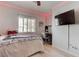 Bright bedroom features a window, ceiling fan, and a modern workspace at 9844 Red Horse St, Las Vegas, NV 89143