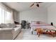 Bright bedroom with modern ceiling fan, natural light, and comfortable seating area at 9844 Red Horse St, Las Vegas, NV 89143