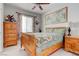 Cozy bedroom with wood furniture, patterned bedding, and ample natural light from the window at 9844 Red Horse St, Las Vegas, NV 89143
