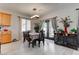Bright dining area featuring stylish lighting, an inviting table setting, and view to a patio through sheer curtains at 9844 Red Horse St, Las Vegas, NV 89143