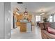Open kitchen with stainless steel appliances, wooden cabinets, and a breakfast bar seamlessly flowing into the living area at 9844 Red Horse St, Las Vegas, NV 89143