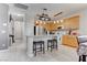 Open kitchen featuring stainless steel appliances, wooden cabinets, a breakfast bar with stylish lighting at 9844 Red Horse St, Las Vegas, NV 89143
