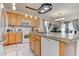 The open kitchen and dining areas boasts wood cabinets, breakfast bar, and stainless appliances at 9844 Red Horse St, Las Vegas, NV 89143