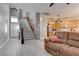 Open-concept home with stairs, light-colored flooring, view into kitchen, and comfortable seating at 9844 Red Horse St, Las Vegas, NV 89143