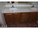Bathroom features a double sink vanity with modern fixtures and tile floors at 10021 Via Toro Ave, Las Vegas, NV 89117
