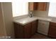 Well-lit kitchen featuring tile countertops, wooden cabinets, and a window over the sink at 10021 Via Toro Ave, Las Vegas, NV 89117
