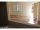 Open living area with tile flooring and natural light, leading to an outdoor space at 10021 Via Toro Ave, Las Vegas, NV 89117