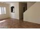 Sunlit living room with tile floors, neutral walls, and an arched opening to the kitchen at 10021 Via Toro Ave, Las Vegas, NV 89117