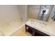 Bathroom featuring double sinks, a shower and tub combo, and tile flooring at 10245 Missouri Meadows St, Las Vegas, NV 89183