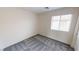 Bright bedroom showcasing carpet and a window with blinds at 10245 Missouri Meadows St, Las Vegas, NV 89183