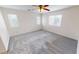 Bright and airy bedroom with new carpeting, three windows, and a ceiling fan at 10245 Missouri Meadows St, Las Vegas, NV 89183