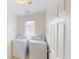 Bright laundry room with washer, dryer, and built-in shelves at 10245 Missouri Meadows St, Las Vegas, NV 89183