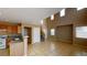 Open-concept living area adjacent to kitchen with bright natural light and tile floors at 10245 Missouri Meadows St, Las Vegas, NV 89183