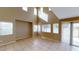 Bright living room featuring tile floors, neutral walls, large windows, and sliding glass door at 10245 Missouri Meadows St, Las Vegas, NV 89183