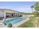 Stunning backyard with a pool, lounge chairs, and beautifully landscaped lawn at 10969 Tranquil Waters Ct, Las Vegas, NV 89135