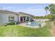 Backyard featuring a pool, patio with outdoor seating, and lush landscaping at 10969 Tranquil Waters Ct, Las Vegas, NV 89135