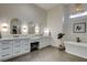 Elegant bathroom with double vanity, stylish mirrors, a freestanding tub, and modern fixtures, creating a spa-like experience at 10969 Tranquil Waters Ct, Las Vegas, NV 89135