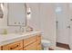 Bright bathroom with a wood vanity, quartz countertop, modern fixtures, and an accessible shower at 10969 Tranquil Waters Ct, Las Vegas, NV 89135