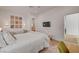 A spacious bedroom featuring neutral tones, a comfortable bed, and stylish decor at 10969 Tranquil Waters Ct, Las Vegas, NV 89135