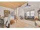 Bedroom with vaulted wood ceiling, ceiling fan, large windows, and a lounge area with workspace at 10969 Tranquil Waters Ct, Las Vegas, NV 89135
