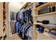 Spacious closet featuring organized shelving, hanging rods, and dedicated sections for shoes, ties, and accessories at 10969 Tranquil Waters Ct, Las Vegas, NV 89135