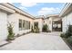 Expansive front courtyard with decorative stone, modern planters, and a sleek entry with large windows at 10969 Tranquil Waters Ct, Las Vegas, NV 89135