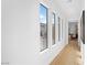 Bright hallway with large windows, hardwood floors, and views of the outside landscaping at 10969 Tranquil Waters Ct, Las Vegas, NV 89135