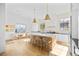 Bright kitchen featuring stainless steel appliances, large island, and a breakfast nook with bench seating at 10969 Tranquil Waters Ct, Las Vegas, NV 89135
