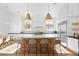 Bright and modern kitchen featuring a large island, stainless steel appliances and stylish pendant lighting at 10969 Tranquil Waters Ct, Las Vegas, NV 89135