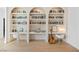 Bright living room features custom built-in bookshelves and desk with white cabinets at 10969 Tranquil Waters Ct, Las Vegas, NV 89135