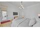Sunlit main bedroom with a large bed, modern TV, and access to the backyard, combining comfort and convenience at 10969 Tranquil Waters Ct, Las Vegas, NV 89135