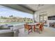 Outdoor patio with dining table and seating overlooking a refreshing backyard pool at 10969 Tranquil Waters Ct, Las Vegas, NV 89135