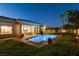 Backyard scene with a private pool, well-manicured lawn, and inviting outdoor dining area at 10969 Tranquil Waters Ct, Las Vegas, NV 89135