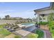 Beautiful backyard pool area featuring a covered patio and lounge chairs at 10969 Tranquil Waters Ct, Las Vegas, NV 89135