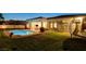 Picturesque backyard featuring a pool, a trampoline, and a well-maintained lawn at 10969 Tranquil Waters Ct, Las Vegas, NV 89135