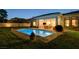 Backyard showcasing a private pool, lush lawn, and outdoor seating for entertainment at 10969 Tranquil Waters Ct, Las Vegas, NV 89135