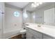 Well-lit bathroom featuring vanity, toilet, bath and shower combination, mirror and round window at 10993 Ladyburn Ct, Las Vegas, NV 89141