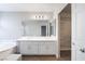 Well-lit bathroom featuring double sinks, a soaking tub, and a walk-in closet at 10993 Ladyburn Ct, Las Vegas, NV 89141