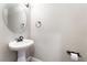 Small half-bathroom with pedestal sink and decorative fixtures at 10993 Ladyburn Ct, Las Vegas, NV 89141