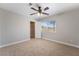 Bright bedroom with a ceiling fan, closet, and natural light from the window overlooking the neighborhood at 10993 Ladyburn Ct, Las Vegas, NV 89141