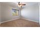 Bedroom with neutral carpeting, ceiling fan, window and outlets at 10993 Ladyburn Ct, Las Vegas, NV 89141