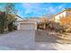Beautiful two-story home featuring a front yard, a two-car garage, and a brick driveway at 10993 Ladyburn Ct, Las Vegas, NV 89141